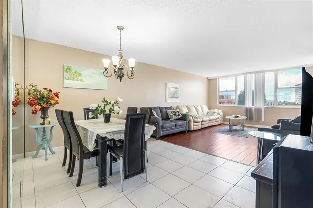a view of a dining room with furniture and chandelier