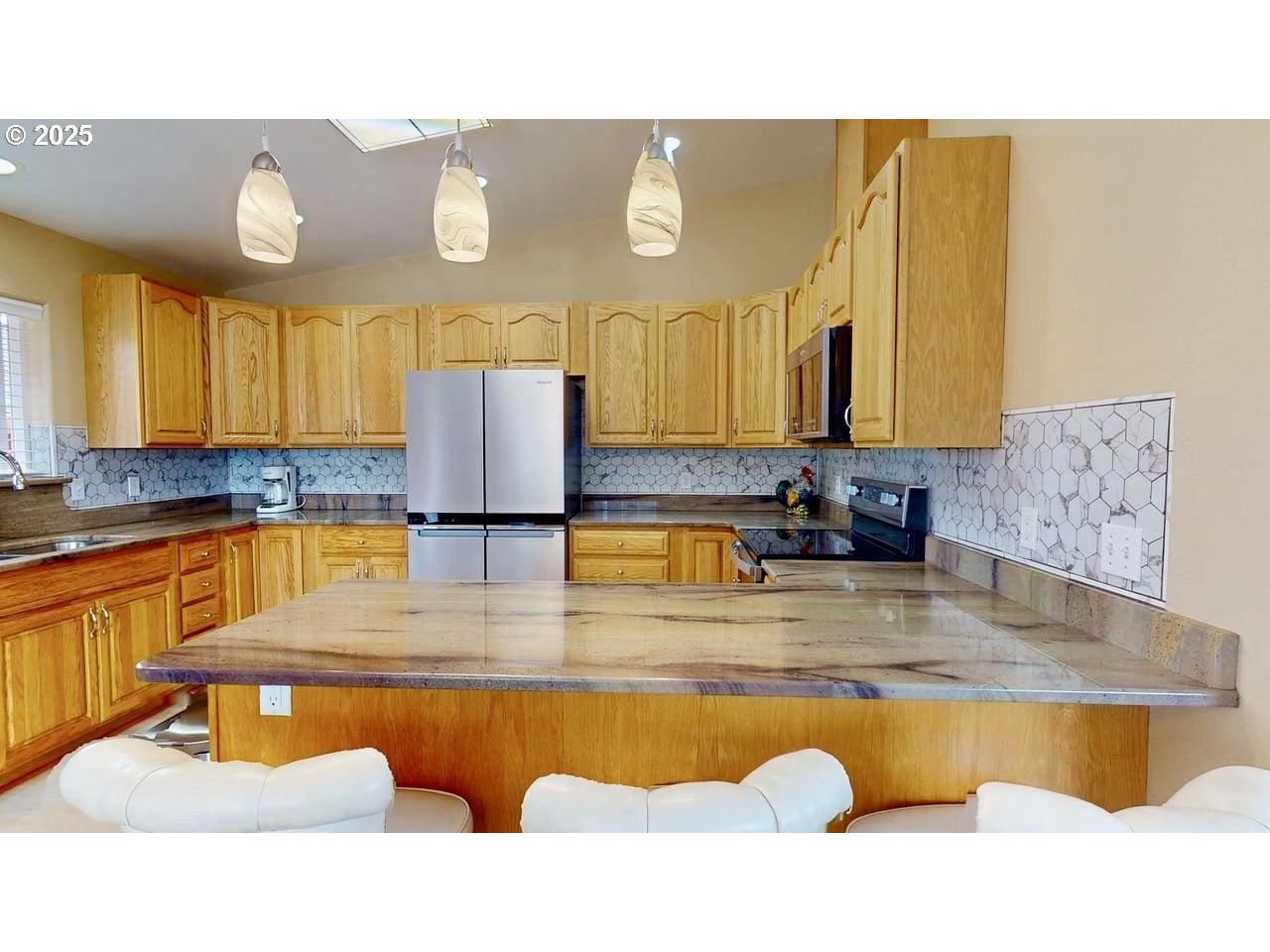 869 North Collier Street Coquille, OR 97423 - Photo 12 of 41 a kitchen with stainless steel appliances granite countertop a sink refrigerator and cabinets