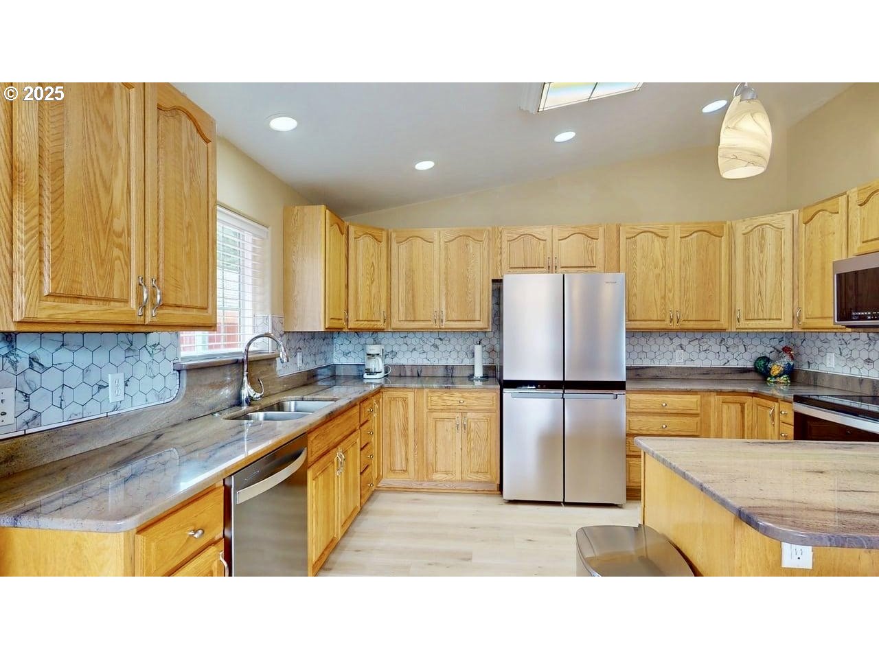 869 North Collier Street Coquille, OR 97423 - Photo 13 of 41 a kitchen with stainless steel appliances granite countertop a sink counter space and a refrigerator