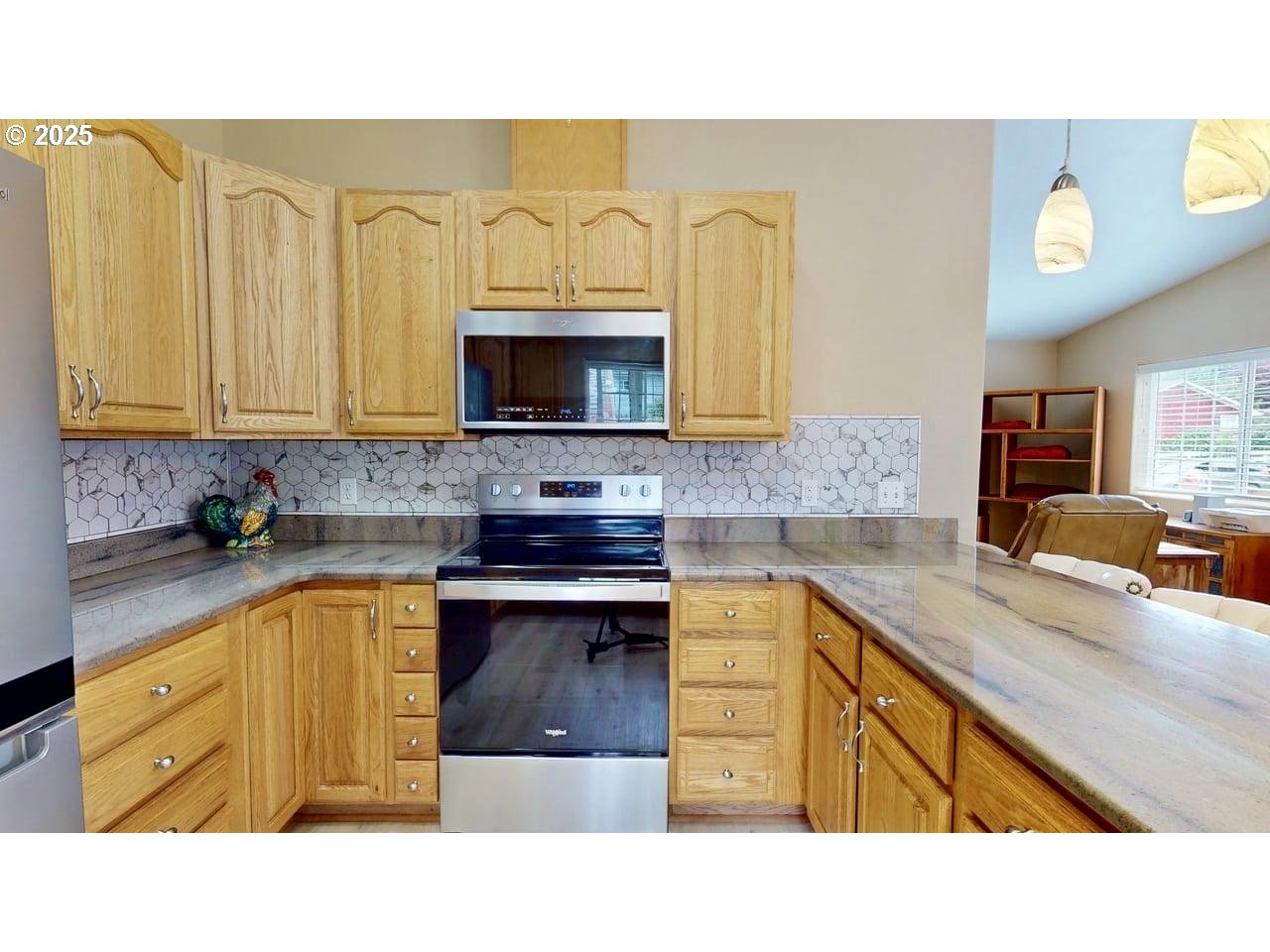 869 North Collier Street Coquille, OR 97423 - Photo 14 of 41 a kitchen with stainless steel appliances granite countertop a sink stove and microwave