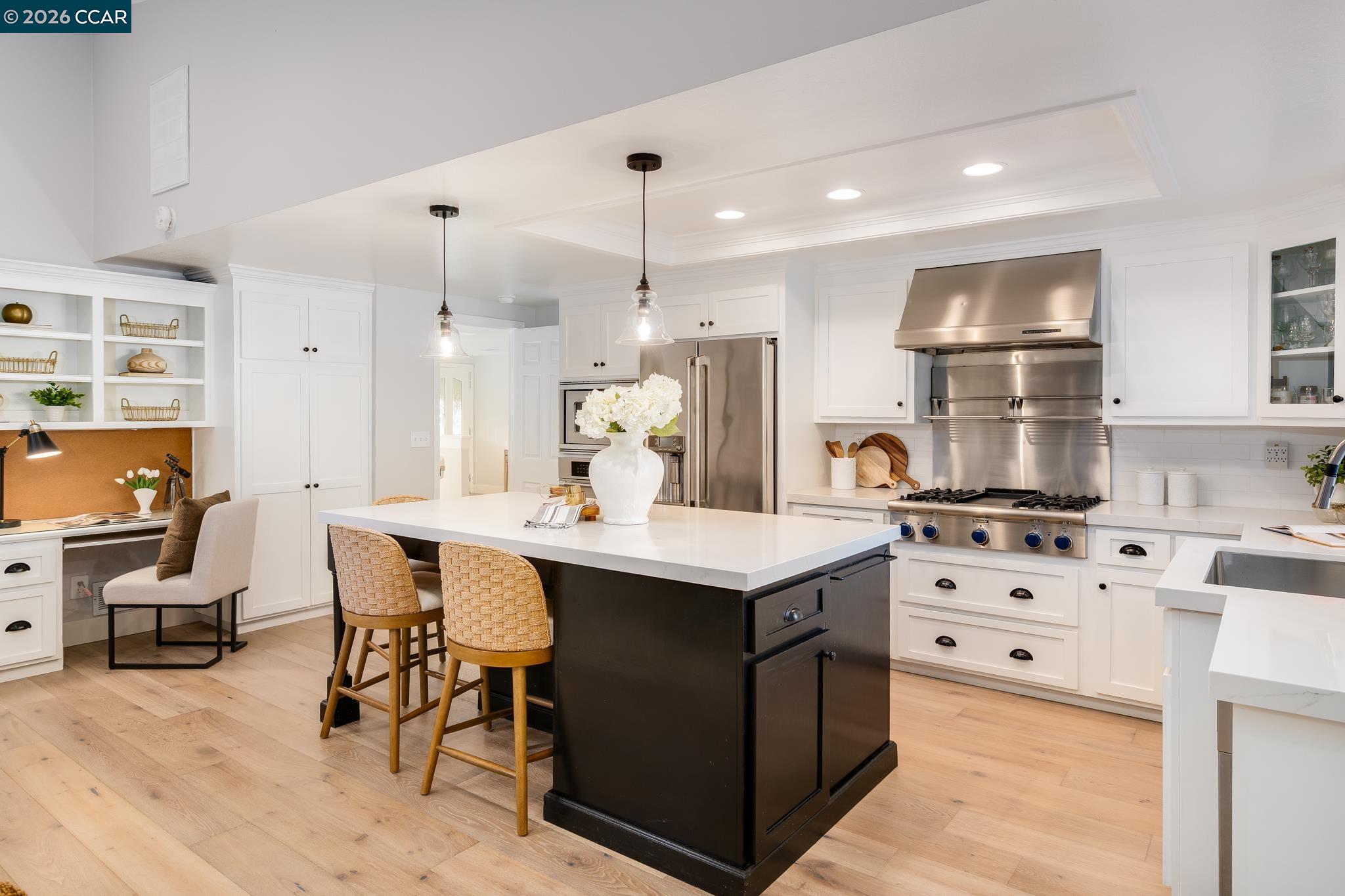 34 Pony Court San Ramon, CA 94583 - Photo 12 of 34 a kitchen with stainless steel appliances kitchen island granite countertop a sink and a refrigerator