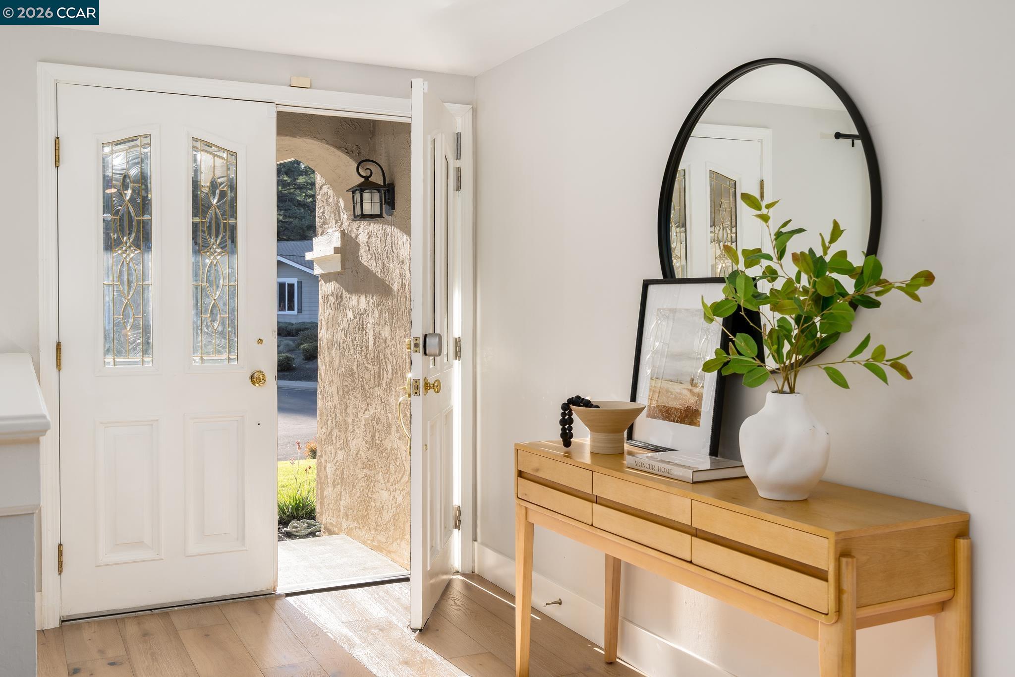 34 Pony Court San Ramon, CA 94583 - Photo 2 of 34 a vase of flowers sitting on a table with a mirror