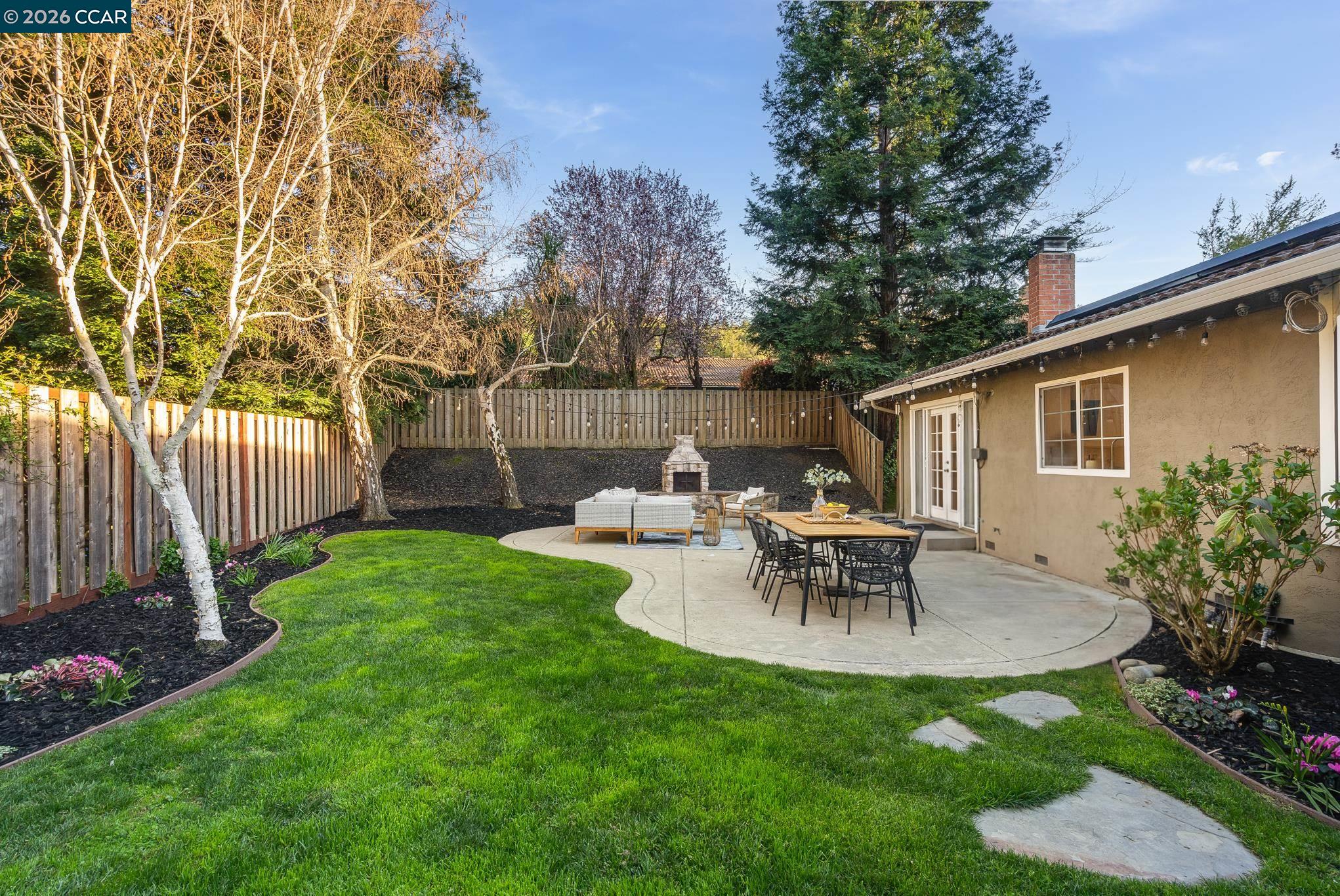 34 Pony Court San Ramon, CA 94583 - Photo 26 of 34 a view of a patio with table and chairs and potted plants with wooden fence