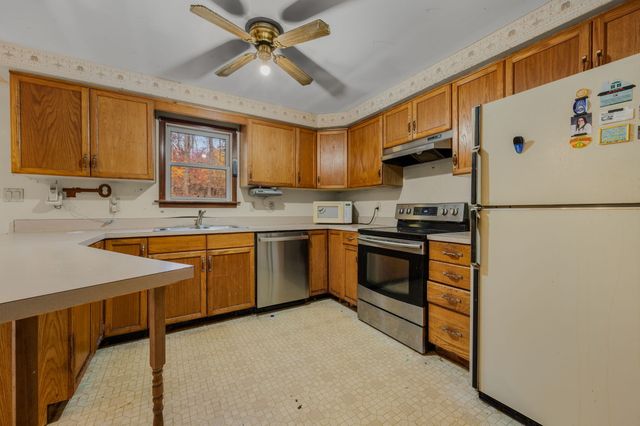 a kitchen with a sink appliances and cabinets