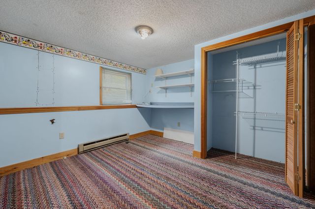 a view of a room with wooden floor and cabinet