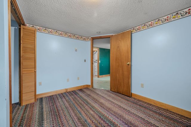 a view of a room with wooden floor and a window