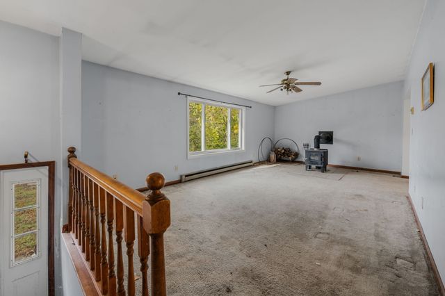 a view of a livingroom with furniture and a window