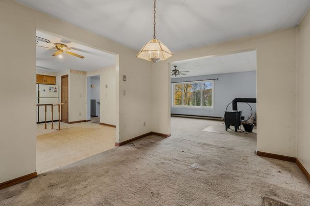 a view of a livingroom with a furniture staircase and a ceiling fan