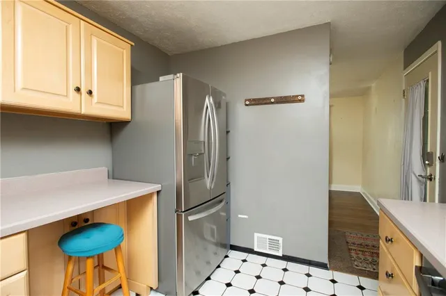 a kitchen with stainless steel appliances granite countertop a refrigerator and a stove