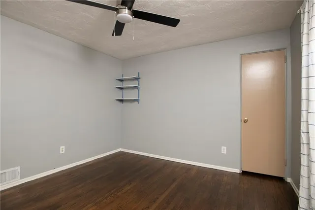 a view of a room with wooden floor