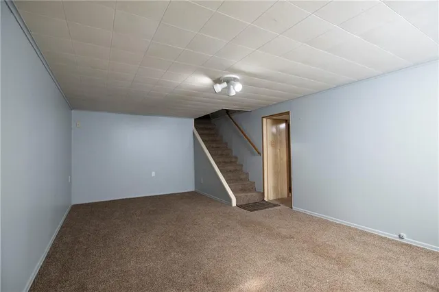 an empty room with a chandelier fan