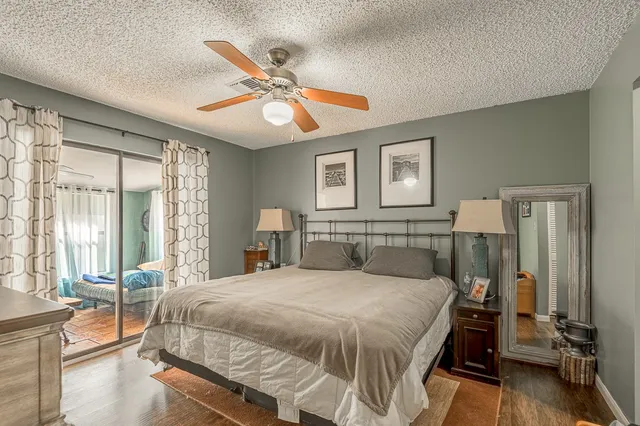 a bedroom with a large bed and a chandelier