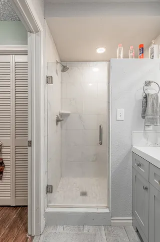 a bathroom with a shower and a sink