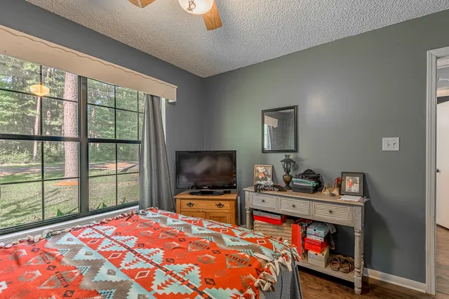 a bedroom with a bed and a flat screen tv