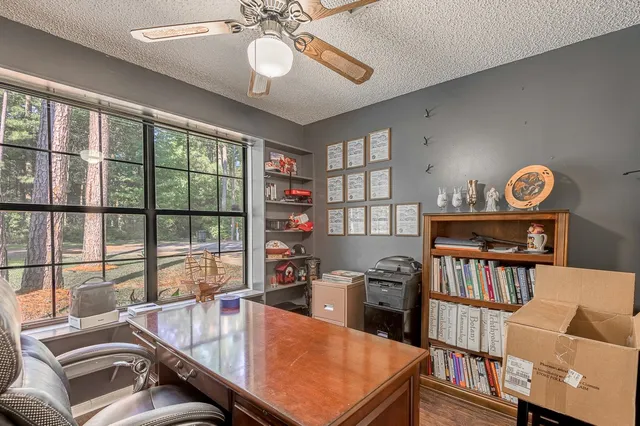 a dining room with furniture a rug and a large window