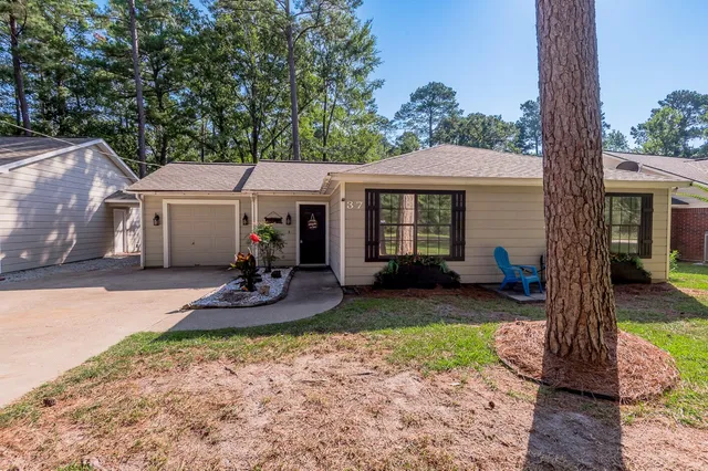 a view of a patio with table and chairs under an umbrella