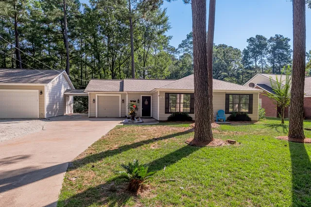 a front view of a house with a yard and porch