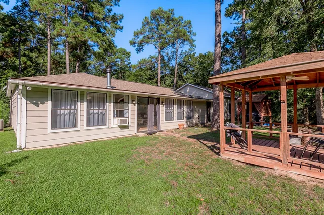 a view of a house with a yard and sitting area