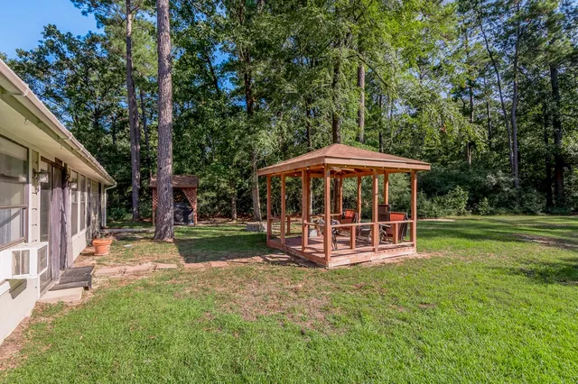 a view of a house with a yard porch and sitting area