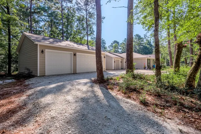 a view of a house with backyard and garden