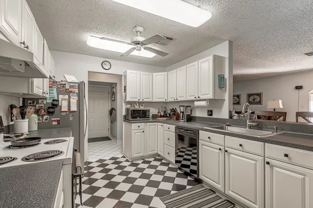 a kitchen with granite countertop appliances cabinets and a sink