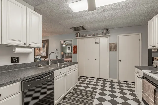 a kitchen with a sink stove and cabinets