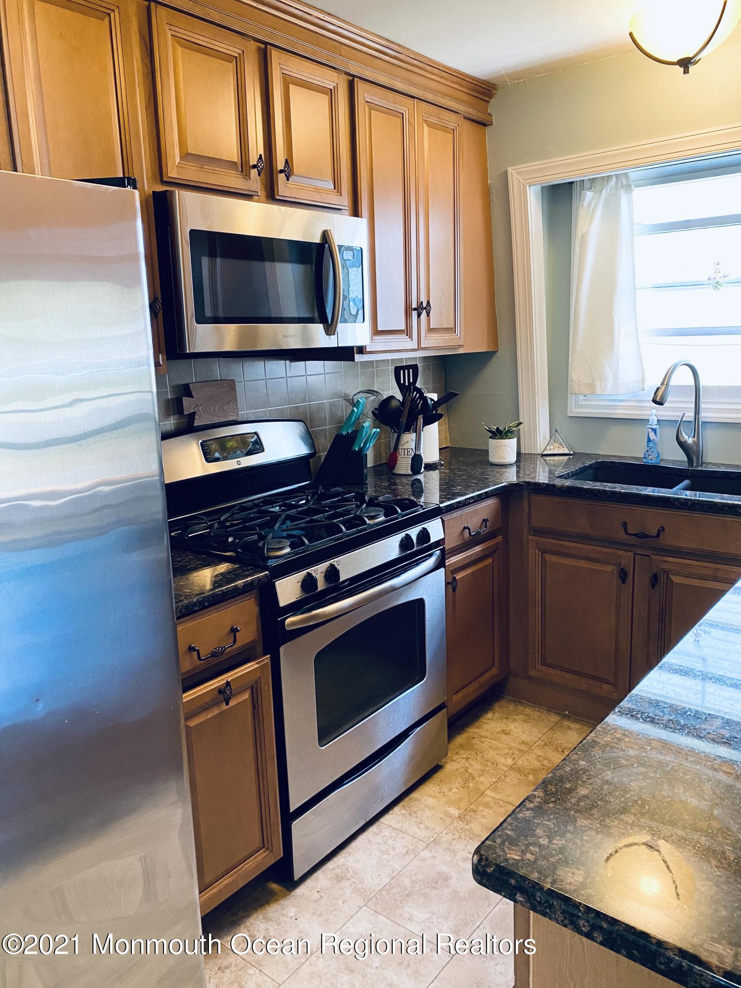 103 George Road Toms River, NJ 08753 - Photo 11 of 34 a kitchen with sink a microwave a stove and cabinets