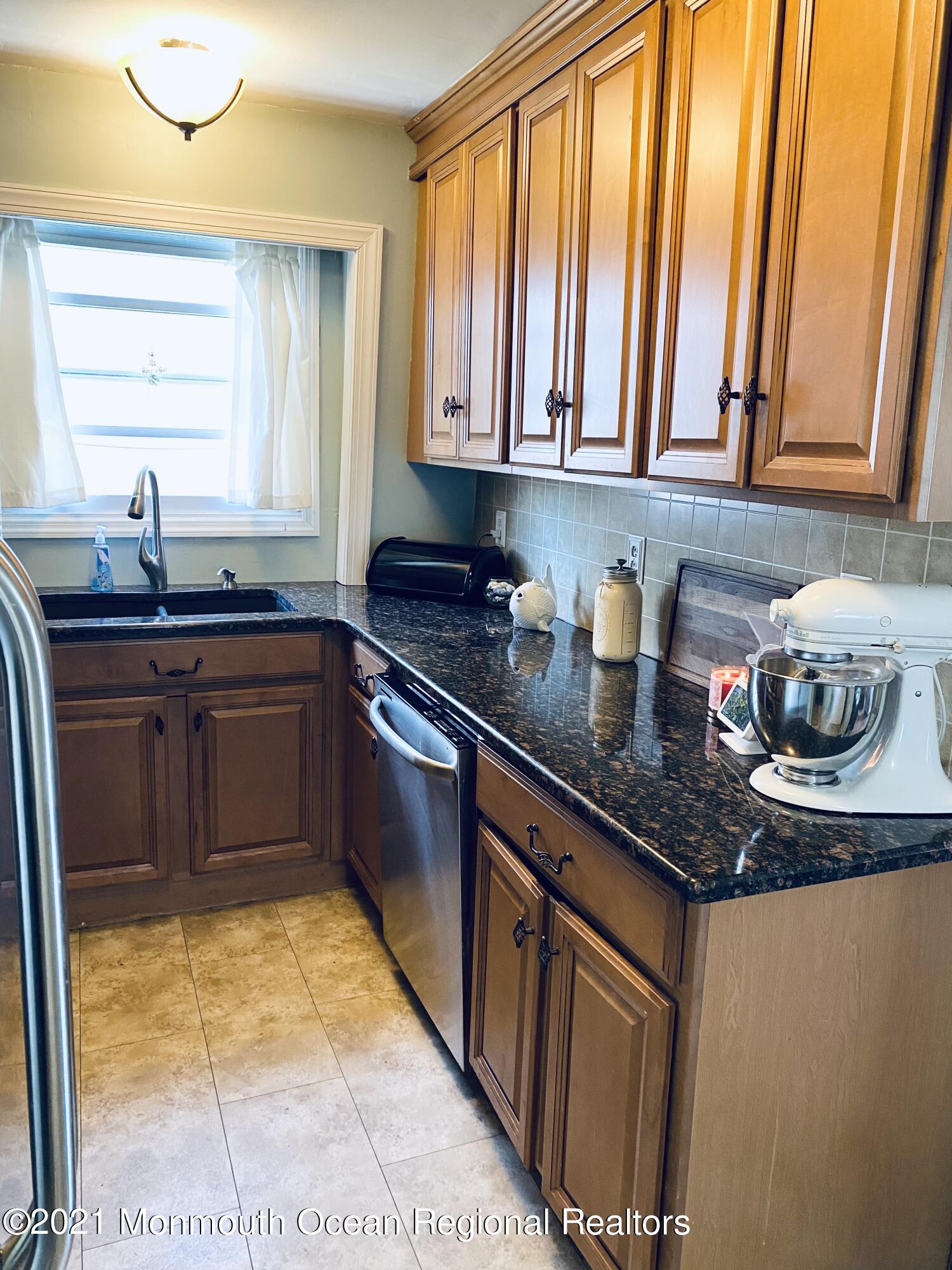 103 George Road Toms River, NJ 08753 - Photo 12 of 34 a kitchen with stainless steel appliances granite countertop a sink stove and cabinets