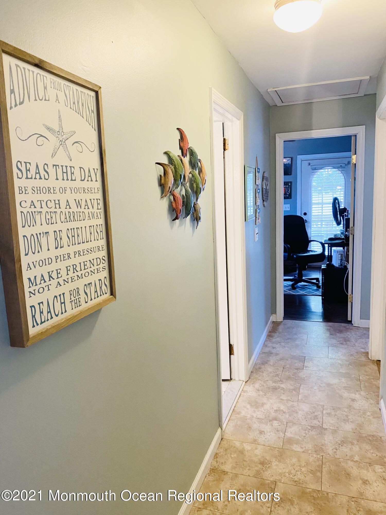 103 George Road Toms River, NJ 08753 - Photo 18 of 34 a view of a hallway to a bedroom with wooden floor and furniture