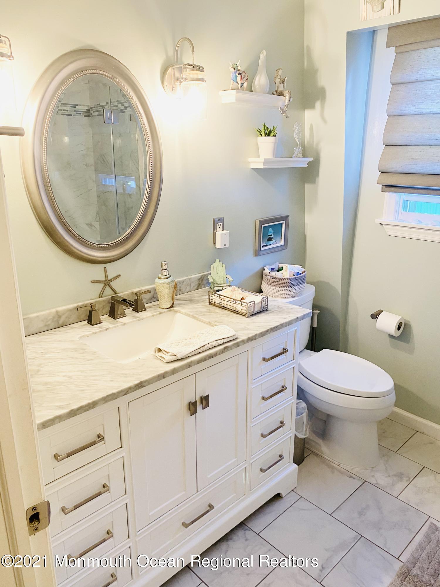 103 George Road Toms River, NJ 08753 - Photo 19 of 34 a bathroom with a sink a toilet and a mirror