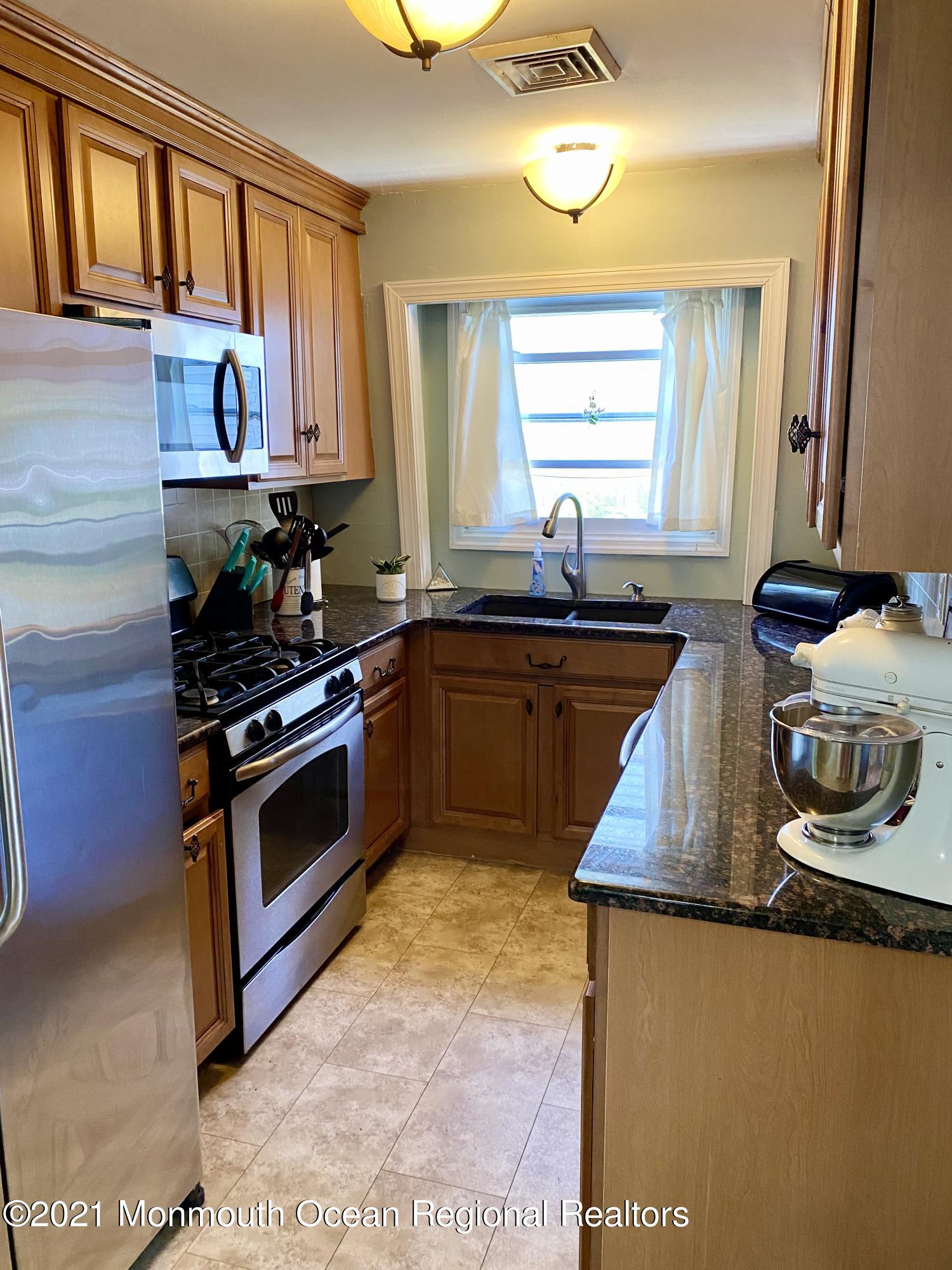 103 George Road Toms River, NJ 08753 - Photo 10 of 34 a kitchen with stainless steel appliances granite countertop a sink stove and window