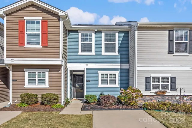 a front view of a house with a yard and a outdoor seating
