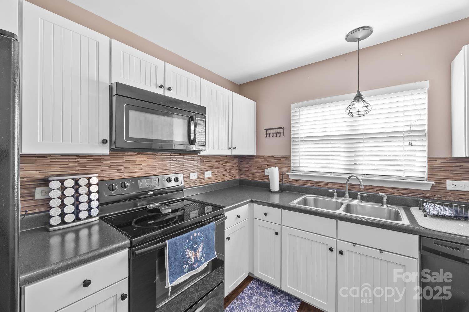 708 Elders Story Road Fort Mill, SC 29708 - Photo 8 of 31 a kitchen with granite countertop a sink a window and stainless steel appliances