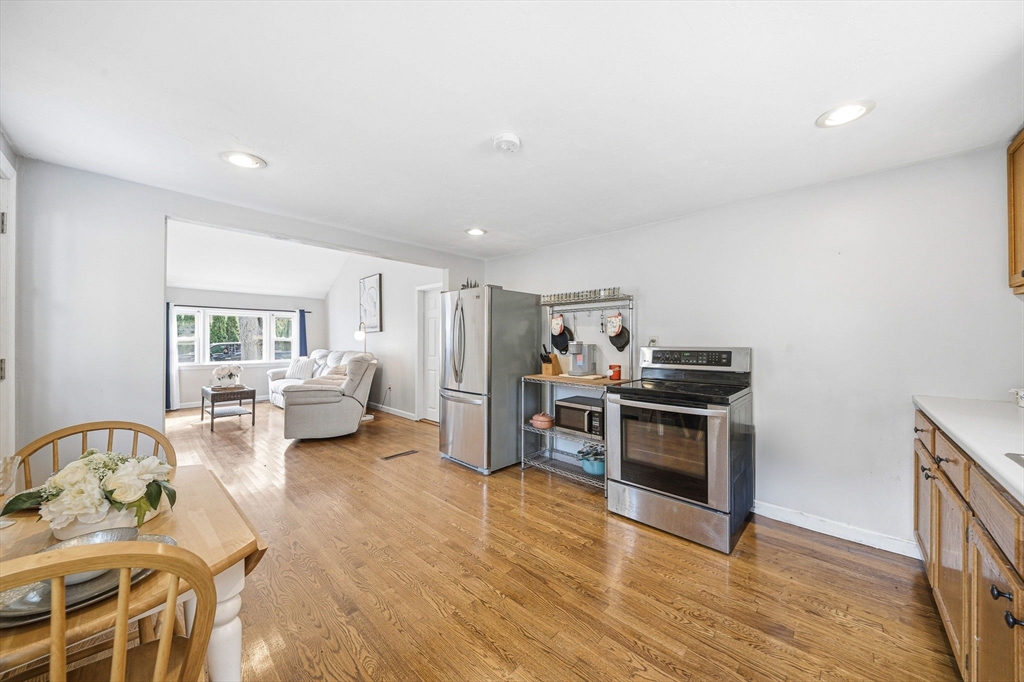 63 Juniper Road Holbrook, MA 02343 - Photo 17 of 35 a living room with furniture and a stove top oven