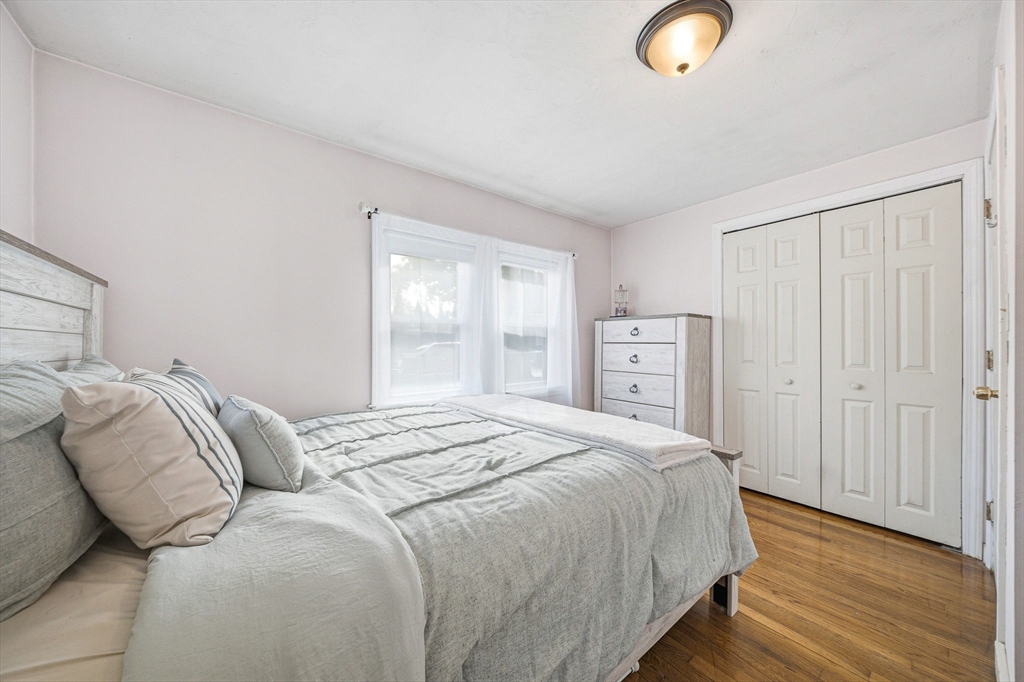 63 Juniper Road Holbrook, MA 02343 - Photo 21 of 35 a bedroom with a bed and wooden floor