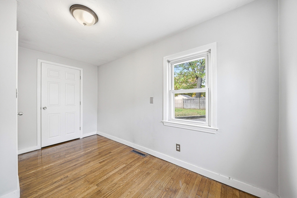 63 Juniper Road Holbrook, MA 02343 - Photo 27 of 35 an empty room with wooden floor and windows