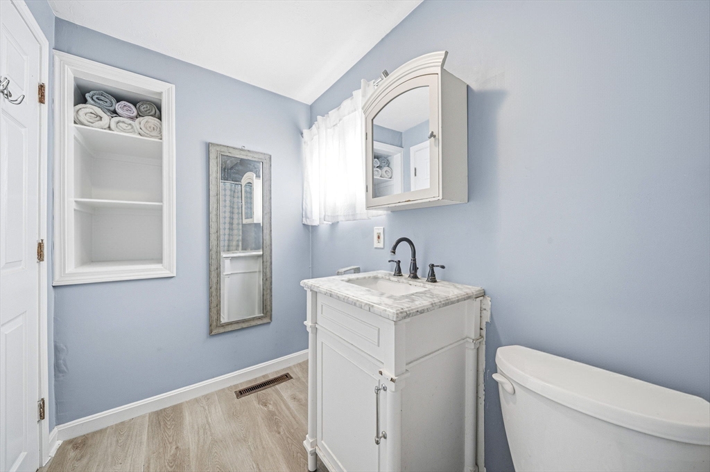 63 Juniper Road Holbrook, MA 02343 - Photo 29 of 35 a bathroom with a toilet sink vanity and mirror
