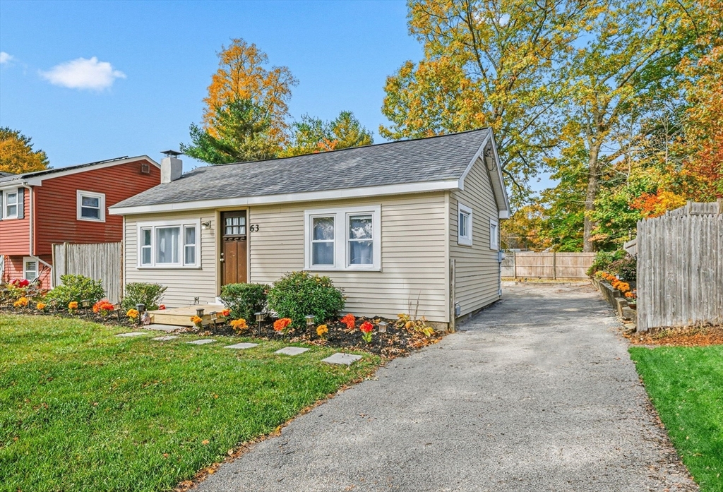 63 Juniper Road Holbrook, MA 02343 - Photo 3 of 35 a front view of a house with a garden and plants