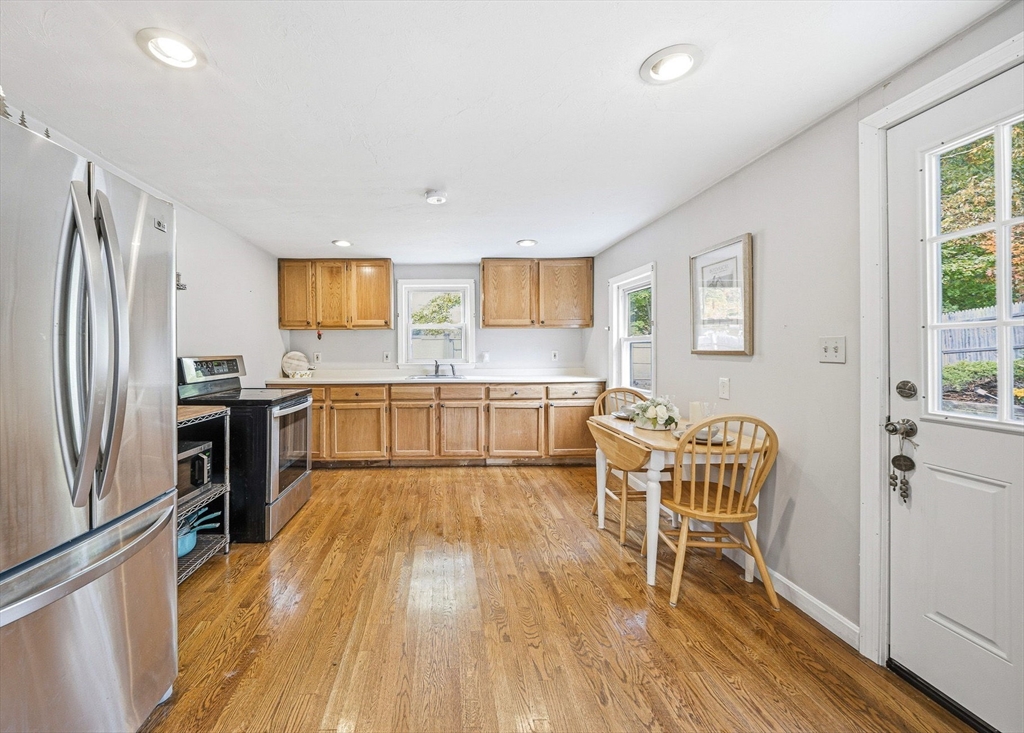 63 Juniper Road Holbrook, MA 02343 - Photo 10 of 35 a kitchen with stainless steel appliances wooden floors and wooden cabinets