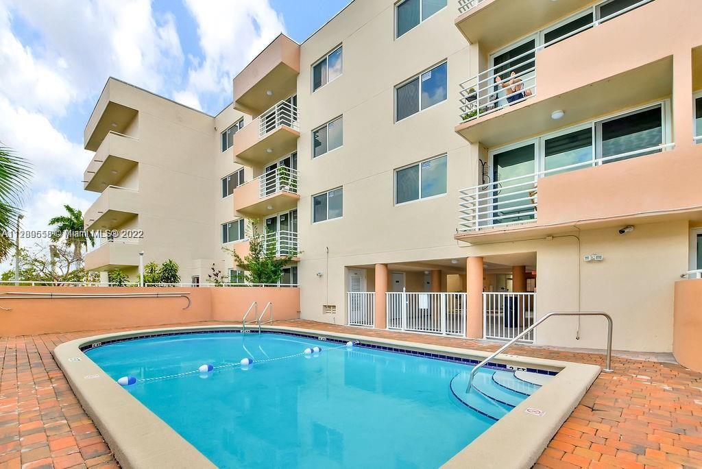 8050 Northwest 8th Street, Unit 201 Miami, FL 33126 - Photo 2 of 13 a view of swimming pool with outdoor seating