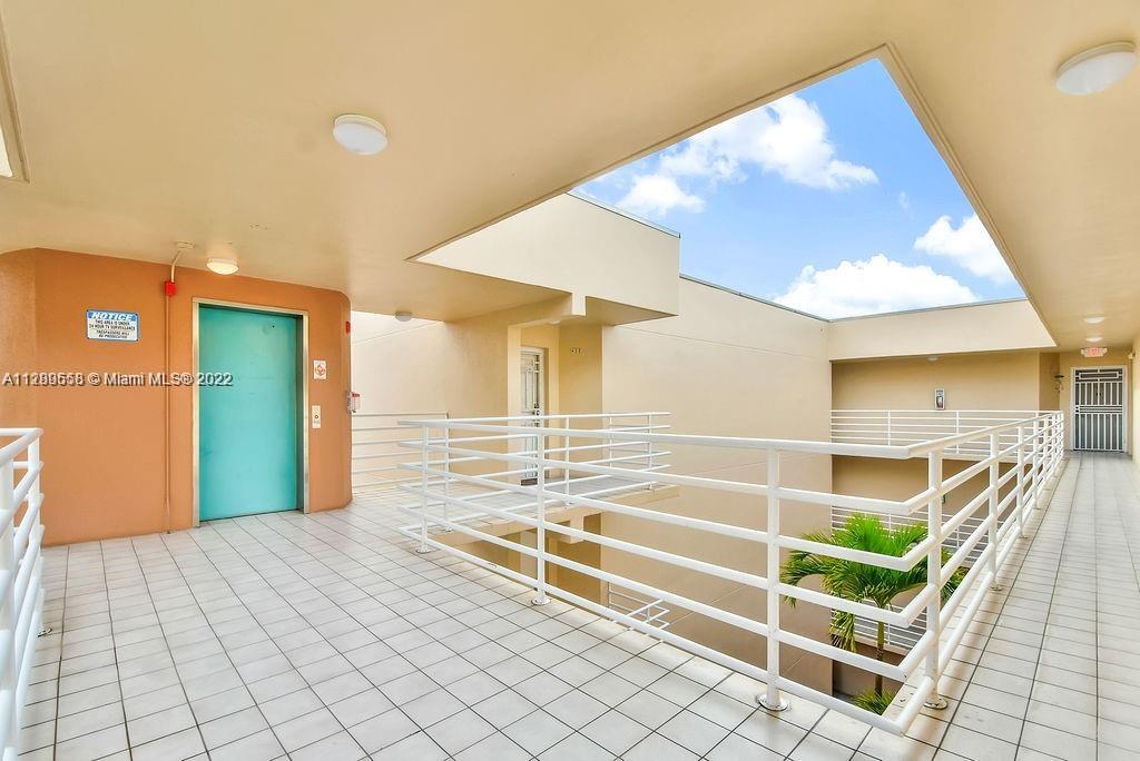 8050 Northwest 8th Street, Unit 201 Miami, FL 33126 - Photo 3 of 13 a view of a hardwood & staircase in a room