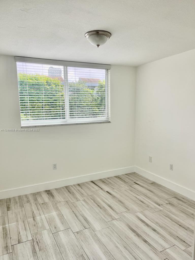 8050 Northwest 8th Street, Unit 201 Miami, FL 33126 - Photo 9 of 13 a view of a room that has a window in it