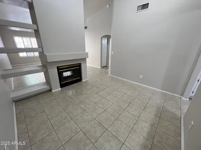 a view of an empty room and fire place