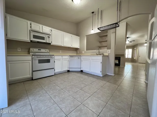 a kitchen with stainless steel appliances granite countertop a stove and a refrigerator