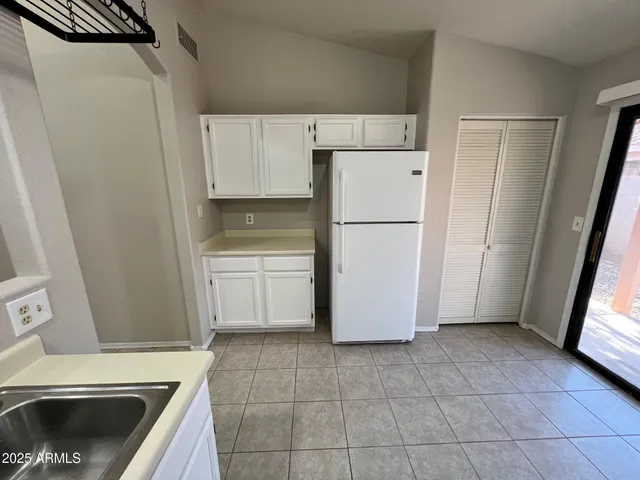 a kitchen with a refrigerator sink stove and cabinets