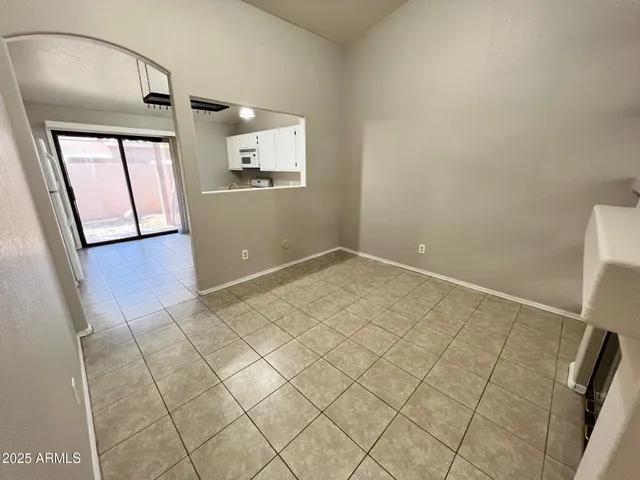 an empty room with windows and entrance