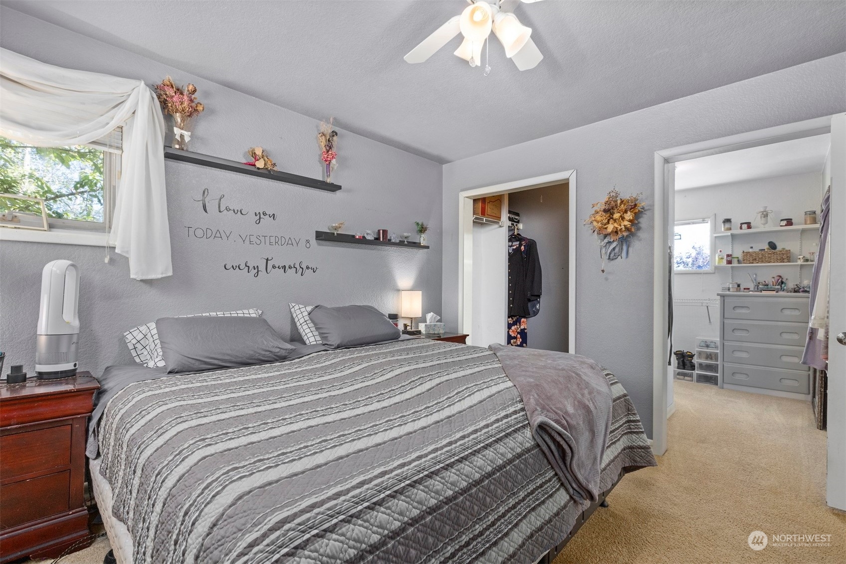 2275 Douglas Road Ferndale, WA 98248 - Photo 17 of 34 a bedroom with a large bed and a chandelier