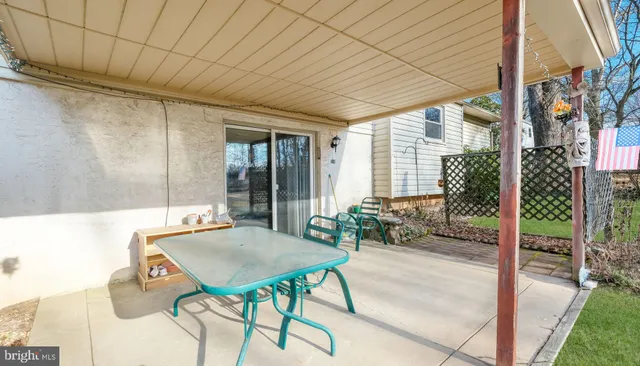 a view of a patio with a table and chairs and potted plants