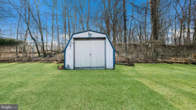 a view of a backyard with large trees