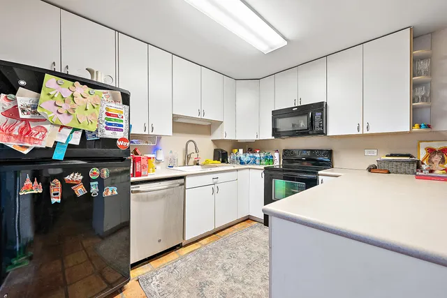 a kitchen with stainless steel appliances granite countertop a refrigerator sink and stove